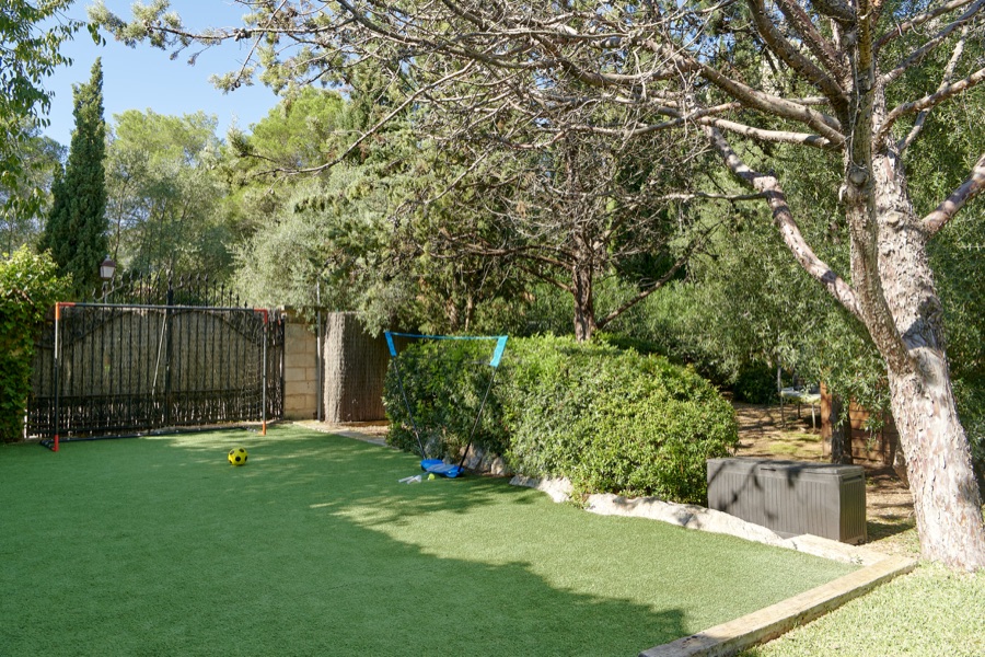 The astro-turf play lawn, trampoline and mature garden