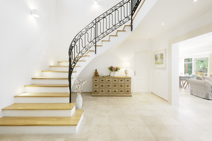 The sweeping staircase and bright entrance hall