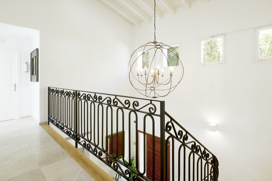 The upstairs landing and wrought-iron stair balustrade