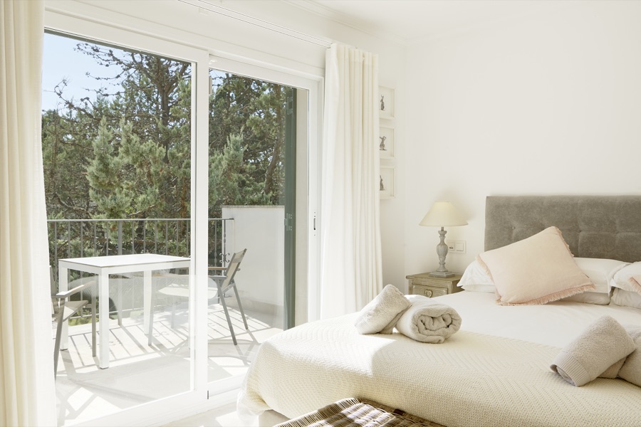 An upstairs bedroom opening onto a private balcony