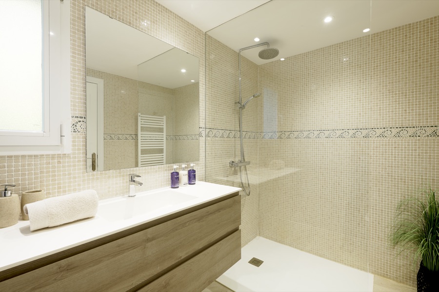 An en-suite bathroom with bath and twin wash basins