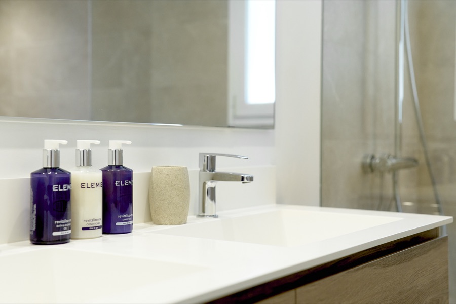 A bathroom wash basin with Elemis toiletries