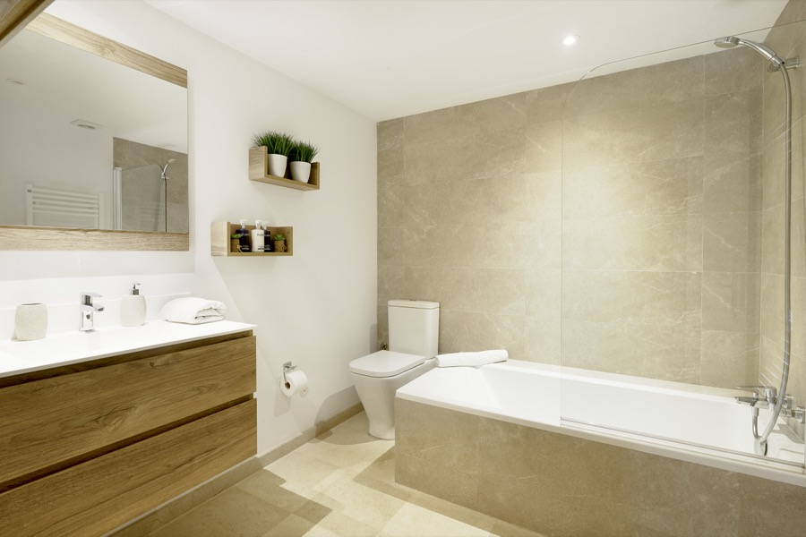 A large en-suite bathroom with bath and vanity unit