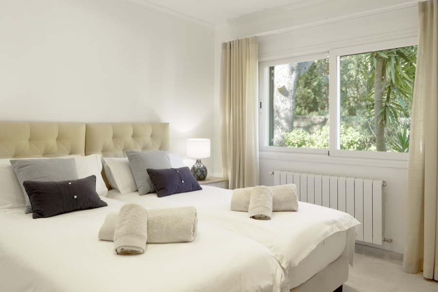 A double bedroom overlooking the mature garden