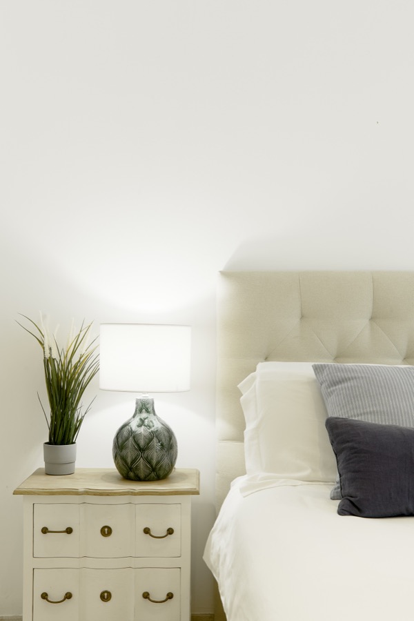 A portrait detail of a bedroom and bedside table