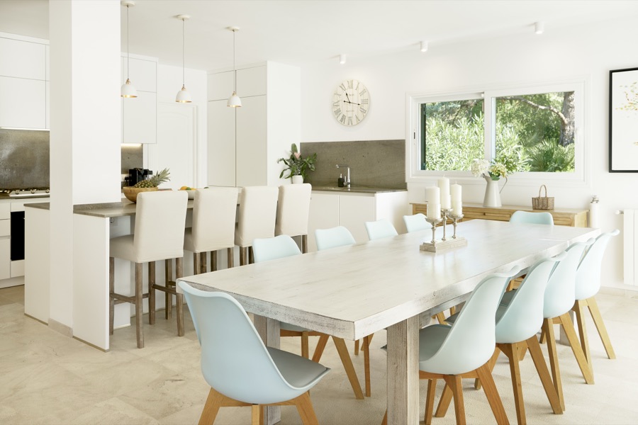 The dining table for ten beside the open-plan kitchen